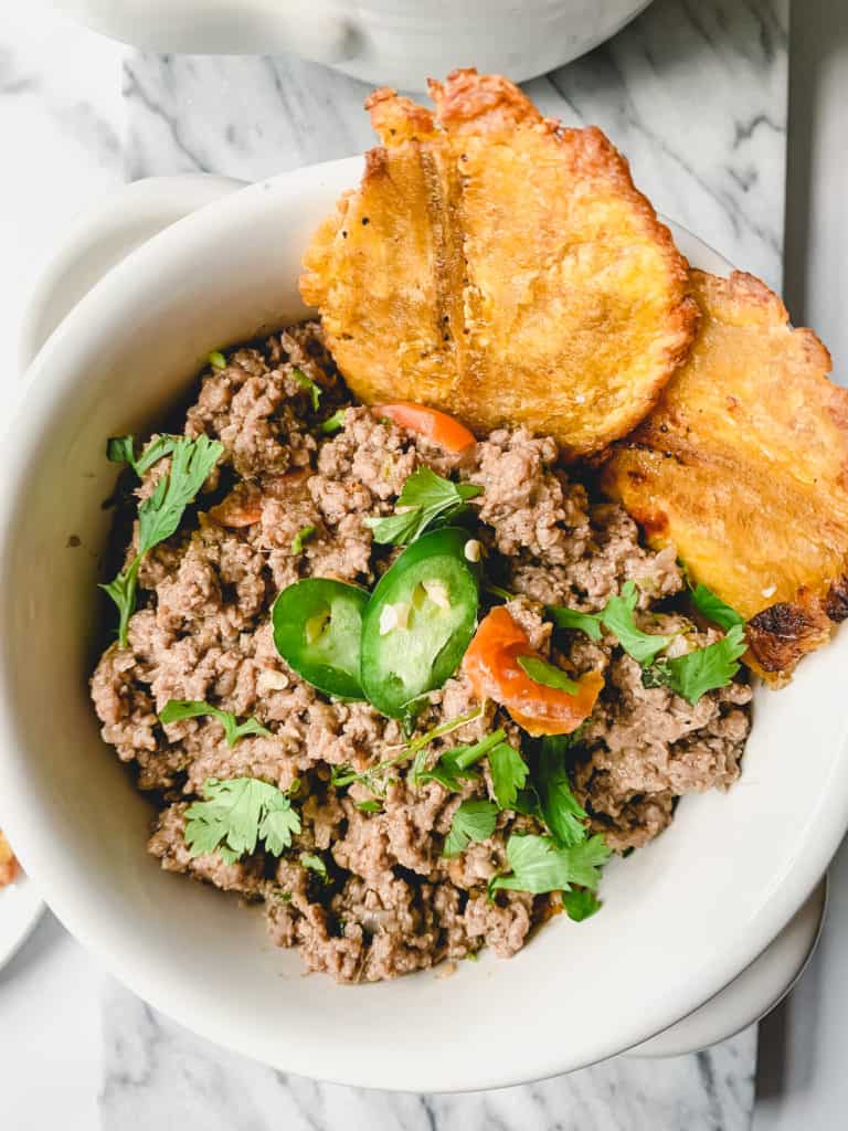 a bowl of lamb keema & garlic tostones