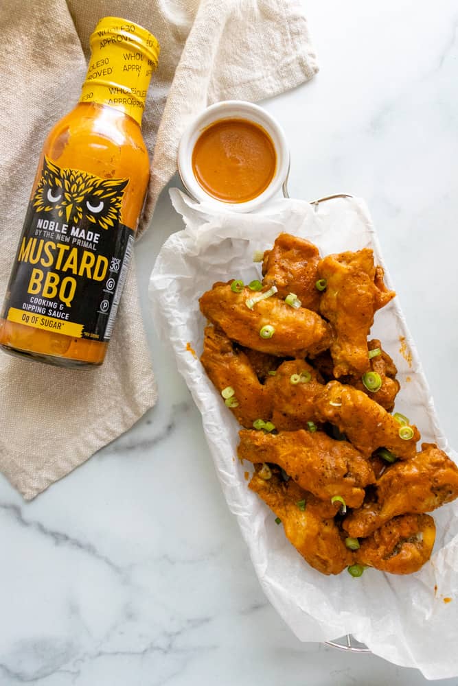 a basket full of mustard bbq chicken wings