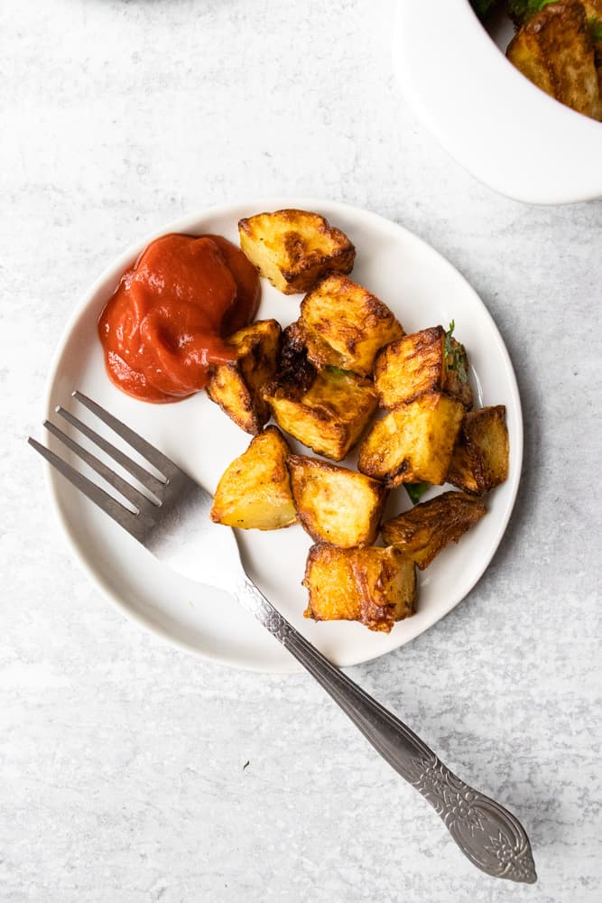 a small play of air fryer home fries and a side of ketchup