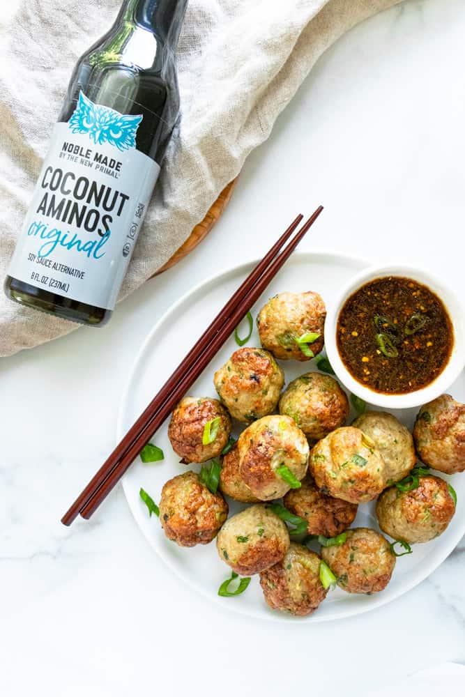 a plateful of pork dumpling meatballs with the coconut aminos dipping sauce