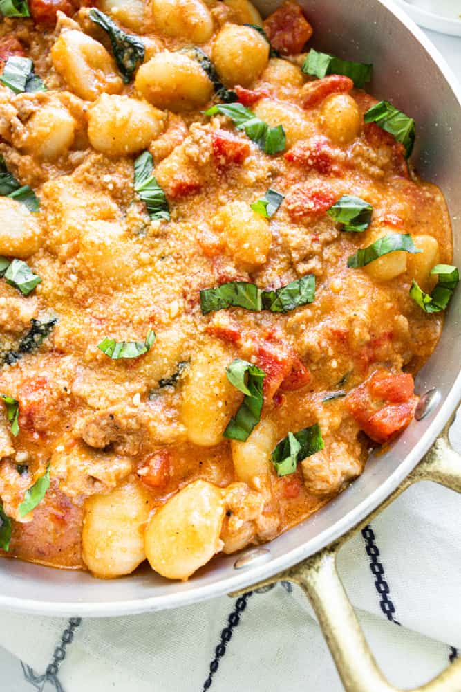 creamy spicy sausage gnocchi in a skillet