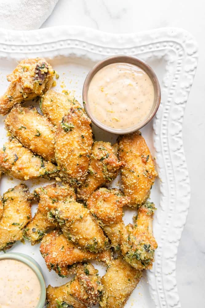 garlic "parmesan" chicken wings on a platter with dipping sauce