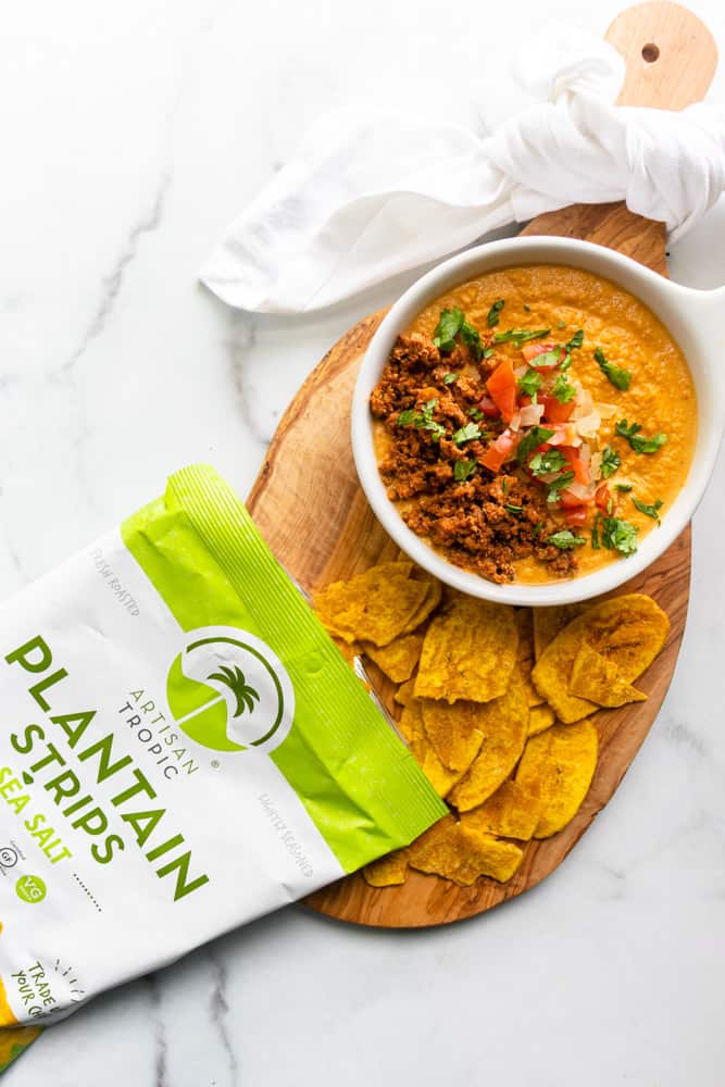 queso fundido con chorizo with a bag of plantain chips