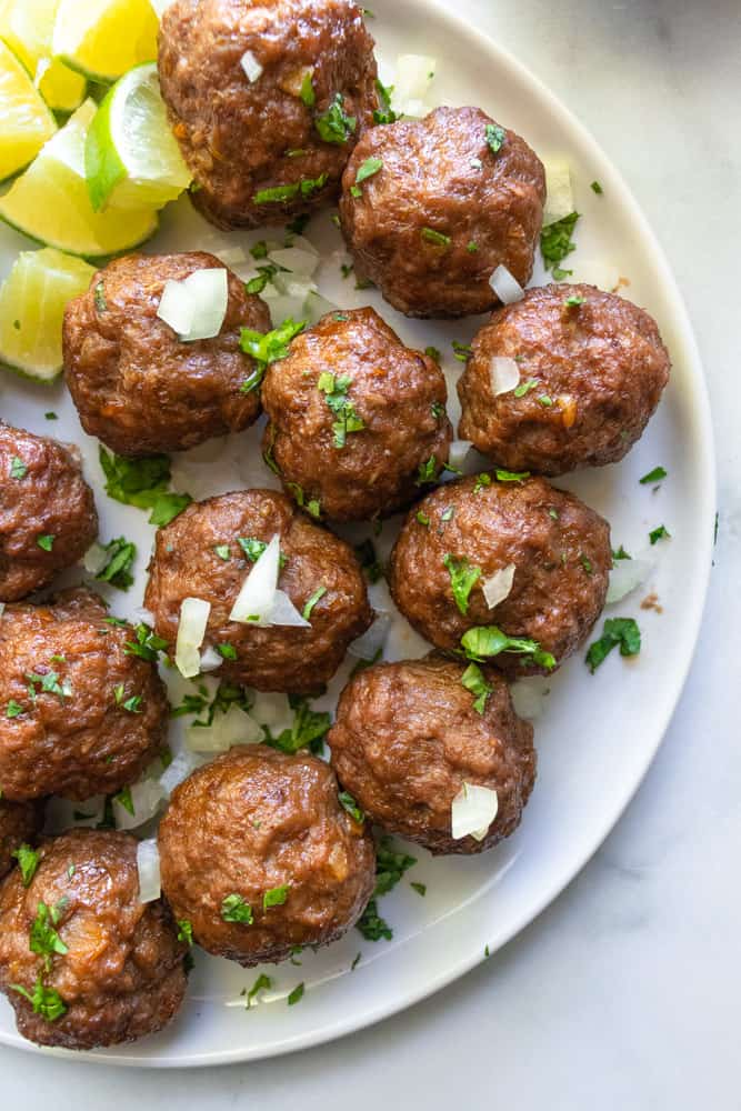 close up of street taco meatballs on a plate