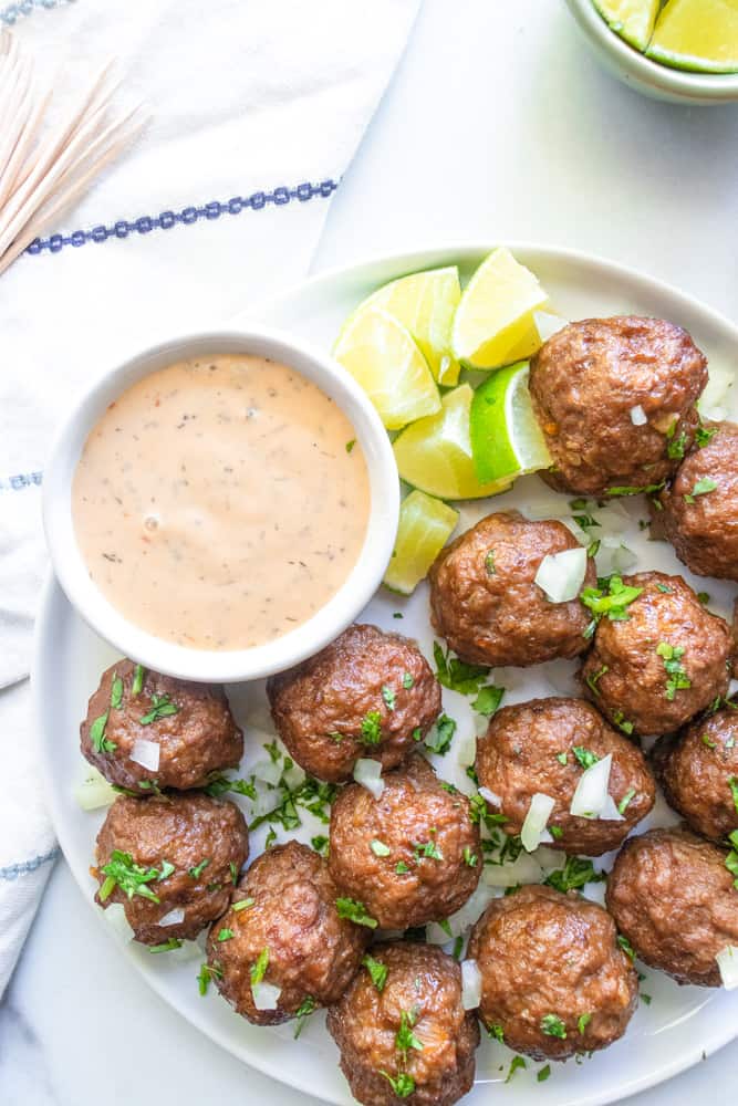 street taco meatballs next to toothpicks and lime wedges