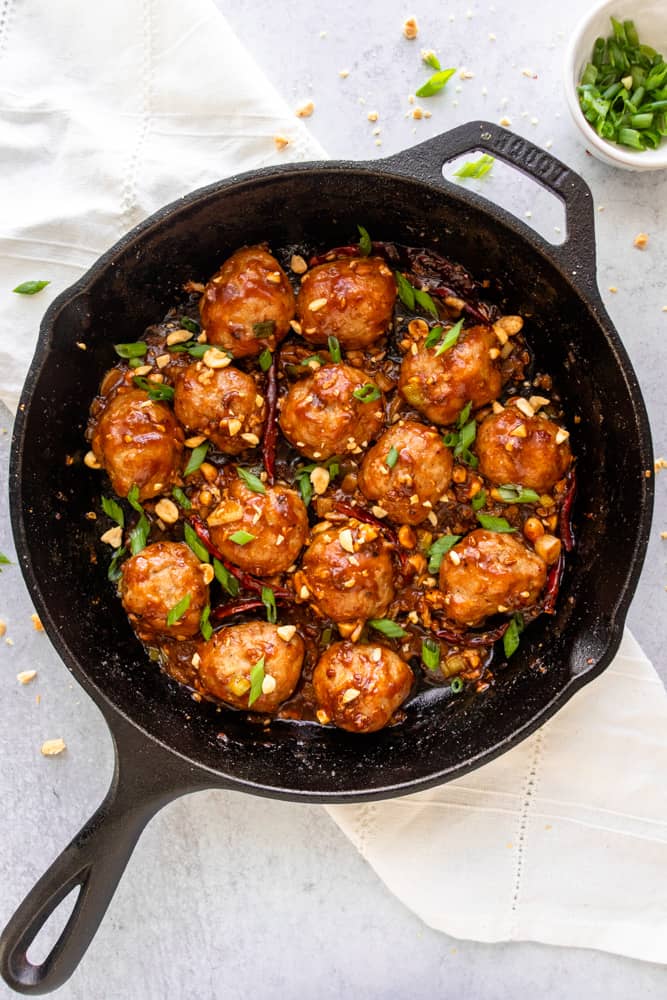 kung pao chicken meatballs in a cast iron skillet