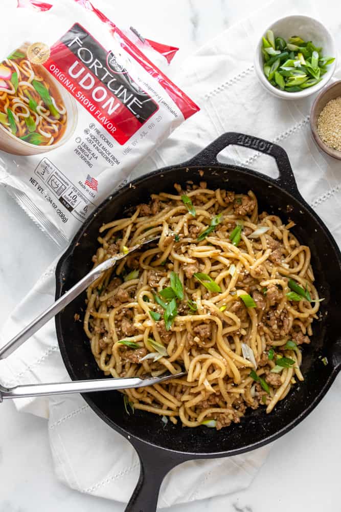 overview of sesame ginger udon stir fry that's in a skillet