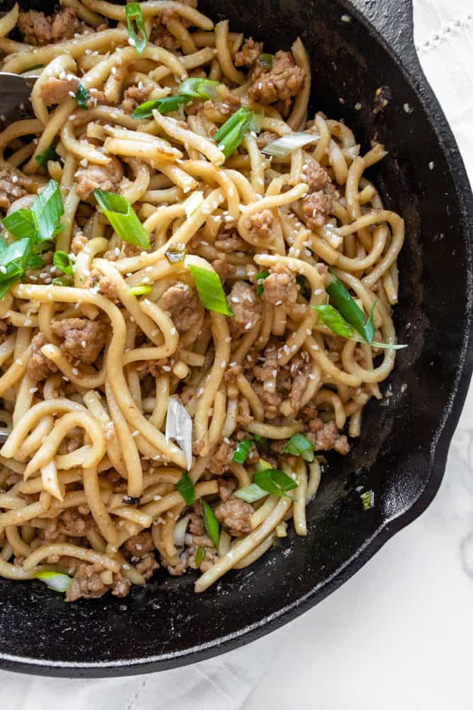 close up of sesame ginger udon stir fry in a skillet