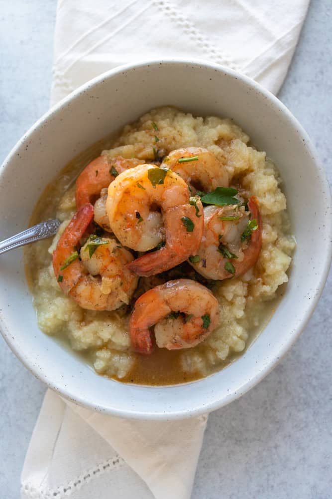 shrimp scampi in a bowl over cauliflower mash