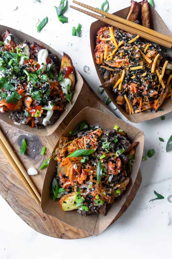 three trays of bulgogi kimchi fries with different toppings