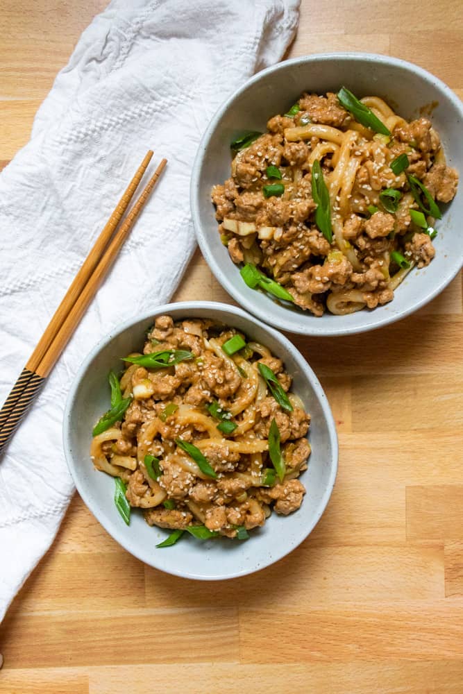 two bowls of peanut garlic udon stir fry