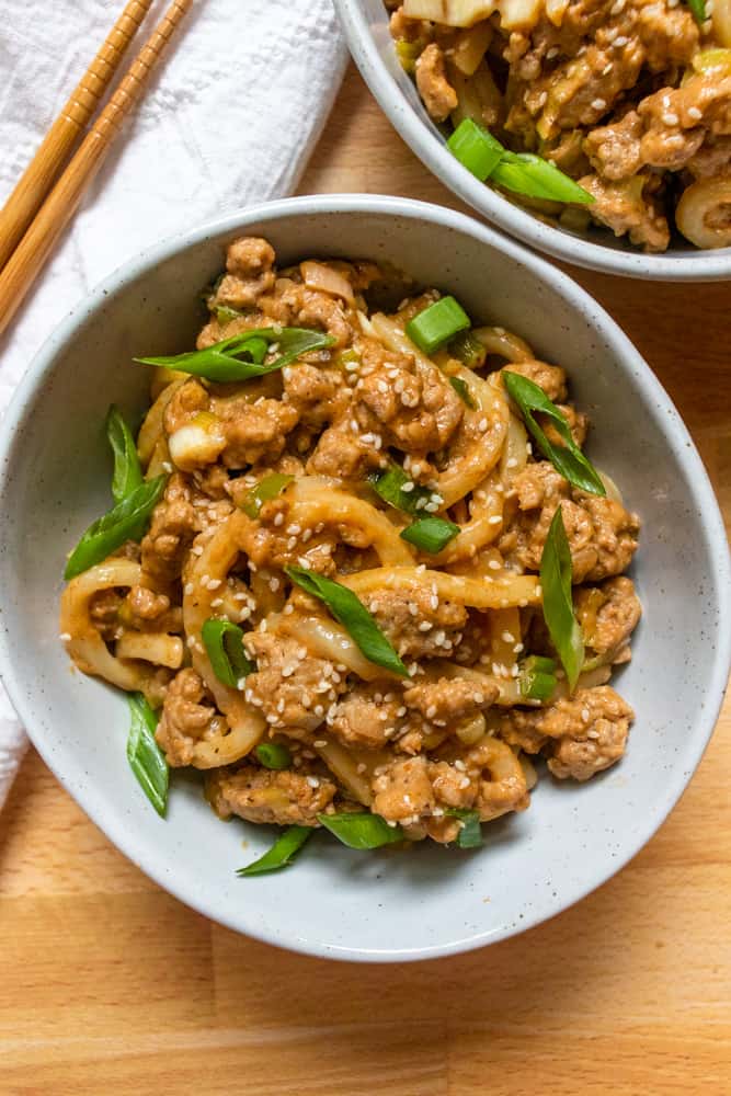 closeup of peanut garlic udon stir fry in a bowl