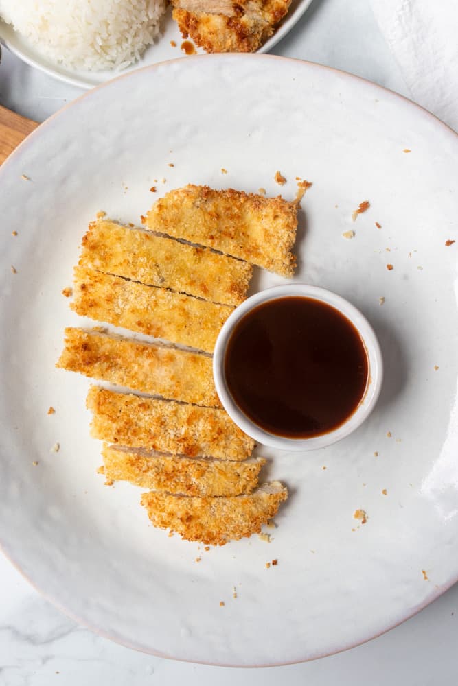 air fryer chicken katsu next to a dipping bowl of tonkatsu sauce