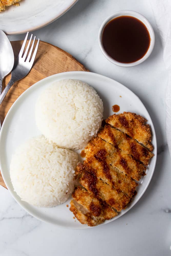 air fryer chicken katsu on a plate with rice and tonkatsu sauce