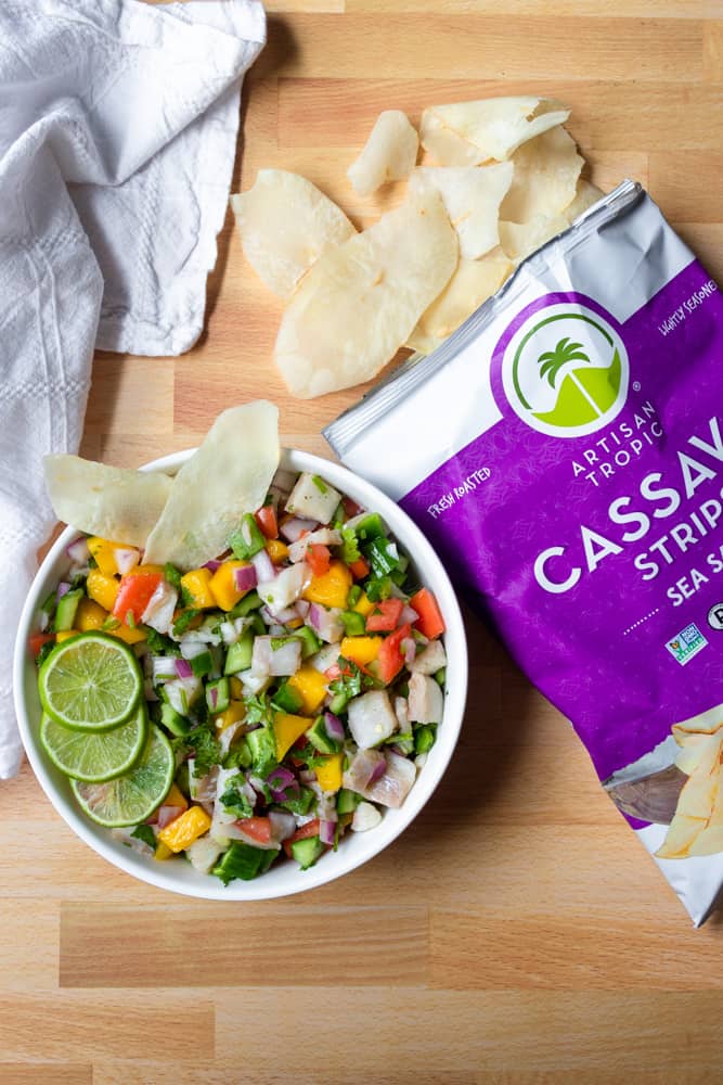 Fish Ceviche (Ceviche de Pescado) in a bowl next to a bag of artisan tropic cassava strips