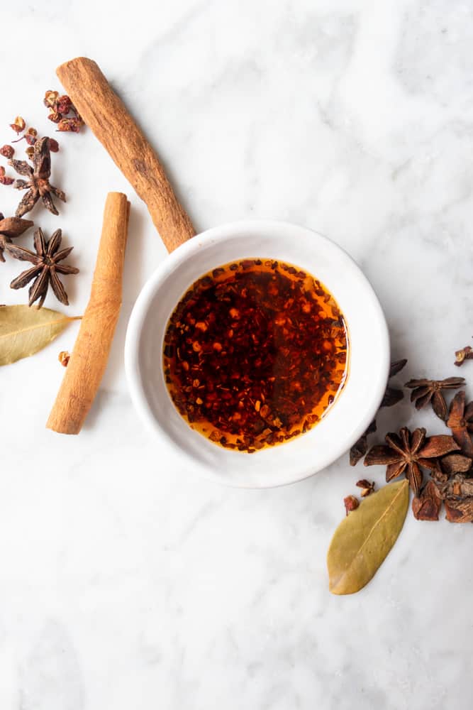 hot chili oil in a small bowl next to aromatics