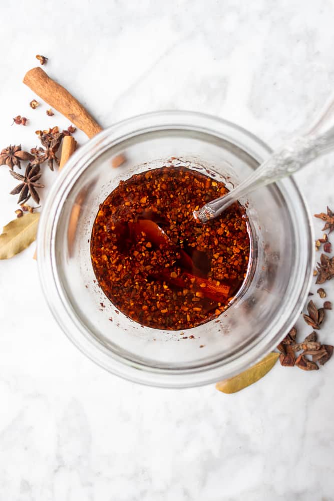 hot chili oil in a jar with a spoon in it