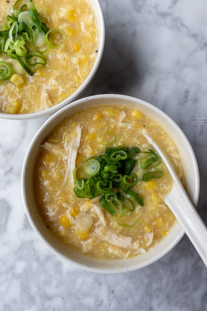 a bowl of Chinese Chicken and Corn Soup with a spoon in it