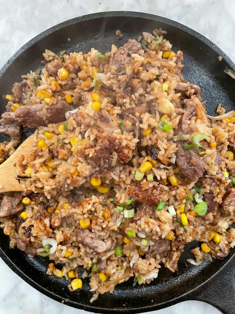 beef. pepper rice on a skillet mixed and cooked through