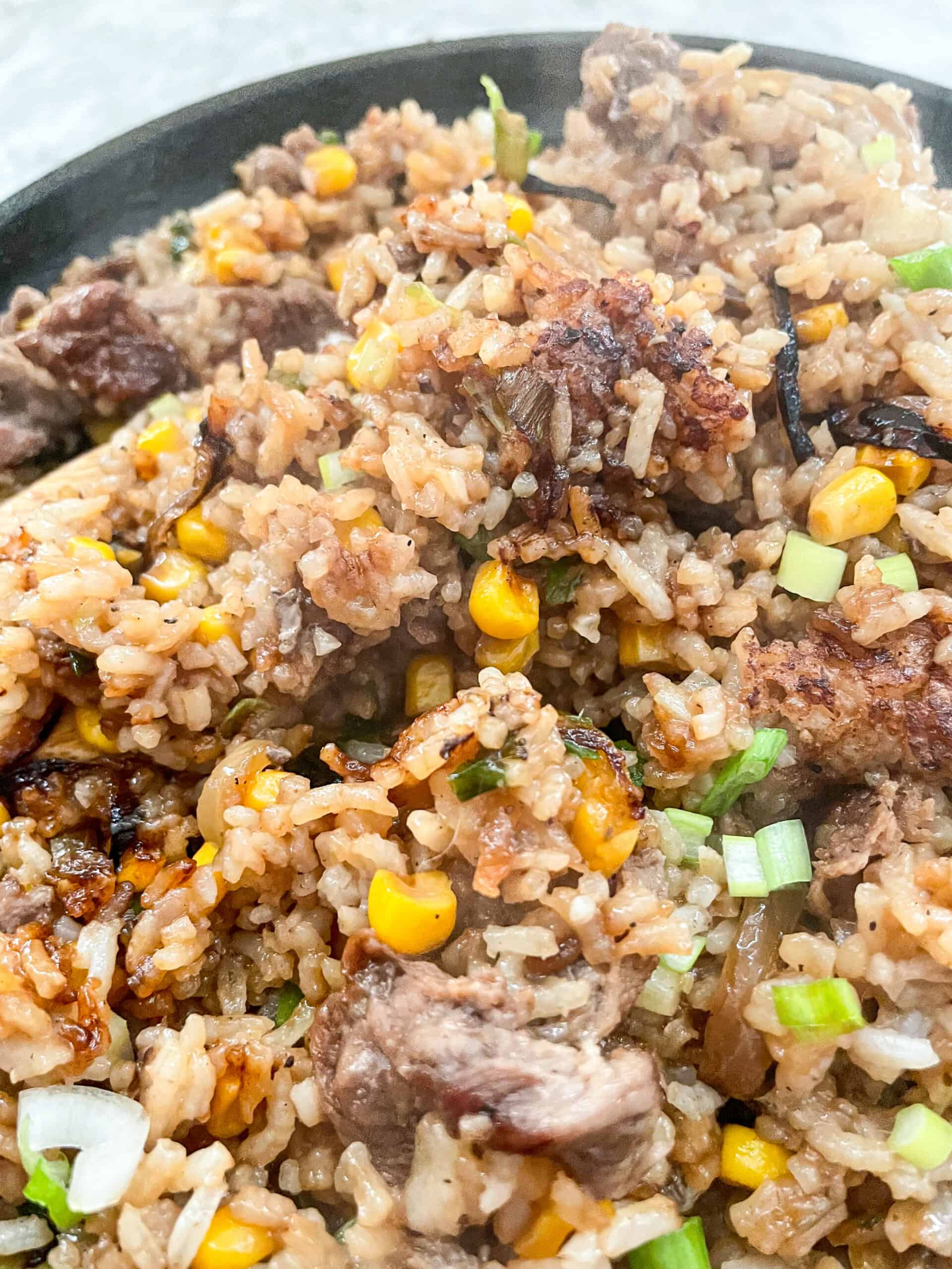 up close of the charred rice of the beef pepper rice